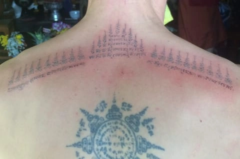 CMLocals Chiang Mai Locals Sak Yant Etiquette monk performing ritual tattoo application with spiritual chanting